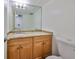 This bathroom features a granite countertop, wood cabinets, and a neutral color scheme at 2424 W Tampa Bay Blvd # I202, Tampa, FL 33607