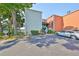 Multi-story building with a parking area and lush green landscaping around the property at 2424 W Tampa Bay Blvd # I202, Tampa, FL 33607