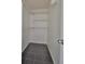 Walk-in closet featuring black tile flooring and white shelving units for optimal storage at 2424 W Tampa Bay Blvd # I202, Tampa, FL 33607