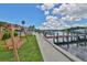 Waterfront view with community docks, waterfront sidewalk, and swings at 2424 W Tampa Bay Blvd # I202, Tampa, FL 33607