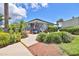 Charming clubhouse exterior with lush landscaping, American flag, and welcoming entrance at 2424 W Tampa Bay Blvd # I202, Tampa, FL 33607