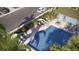 Aerial view of the community pool area featuring lounge chairs, shade, and a bathroom house at 2681 Buttercup Lucine Ln, Ruskin, FL 33570