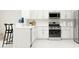 Modern kitchen with stainless steel appliances, white cabinets, and a breakfast bar at 2681 Buttercup Lucine Ln, Ruskin, FL 33570