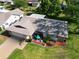 Aerial view of home shows well-maintained lawn, landscaping and a blue outdoor dining set at 2967 Macalpin N Dr, Palm Harbor, FL 34684