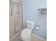 Bathroom featuring a stand up shower, toilet, towel rack and blue walls at 2967 Macalpin N Dr, Palm Harbor, FL 34684