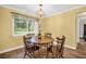 Cozy dining area with a wooden table and chairs, complemented by a bright window at 2967 Macalpin N Dr, Palm Harbor, FL 34684