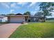 Charming single-story home featuring a two-car garage and a well-maintained front yard at 2967 Macalpin N Dr, Palm Harbor, FL 34684
