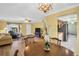 Spacious living and dining area featuring wood floors and modern lighting at 2967 Macalpin N Dr, Palm Harbor, FL 34684