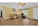 Bright living room with wood floors, neutral furniture, and a view of the outdoors at 2967 Macalpin N Dr, Palm Harbor, FL 34684