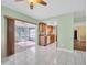 Bright, open floor plan with tile flooring seamlessly connects living space to kitchen and sunroom at 2967 Macalpin N Dr, Palm Harbor, FL 34684