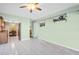 Open layout featuring tile flooring connects kitchen to living and dining areas at 2967 Macalpin N Dr, Palm Harbor, FL 34684