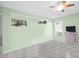 Bright room features tile flooring, ceiling fan, hanging cooking utensils, shelving and window at 2967 Macalpin N Dr, Palm Harbor, FL 34684