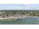 Lovely aerial view features a pier on a bay in a community with lush trees at 3025 50Th St S S St, Gulfport, FL 33707
