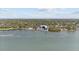 Wide aerial shot shows boat house and docks on the water surrounded by lush trees at 3025 50Th St S S St, Gulfport, FL 33707