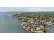 Stunning aerial view of waterfront homes with docks and boats, nestled amidst lush greenery and beautiful city views at 3025 50Th St S S St, Gulfport, FL 33707