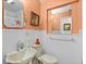 Cozy bathroom featuring white tiling and a traditional-style sink and toilet at 3025 50Th St S S St, Gulfport, FL 33707
