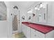 Bright bathroom with dual sinks, red countertop, and decorative wall art at 3025 50Th St S S St, Gulfport, FL 33707
