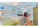Tranquil bedroom offers ample natural light, desk space, hardwood floors and a comfortable bed at 3025 50Th St S S St, Gulfport, FL 33707
