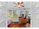 Bedroom with hardwood floors, a ceiling fan, large windows, and a computer desk at 3025 50Th St S S St, Gulfport, FL 33707