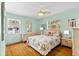 Light and bright bedroom features a large bed, hardwood floors, neutral paint and three windows at 3025 50Th St S S St, Gulfport, FL 33707