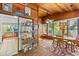 Dining room with wood paneled walls, windows, and a view to the kitchen at 3025 50Th St S S St, Gulfport, FL 33707