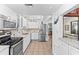 Modern kitchen with white cabinets, stainless steel appliances and tile floors at 3025 50Th St S S St, Gulfport, FL 33707
