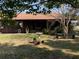 Backyard featuring a screened in porch, lush greenery, and ample room for gardening and outdoor activities at 31258 Park Ridge Dr, Brooksville, FL 34602