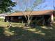Backyard featuring a screened in porch, lush greenery, and ample room for gardening and outdoor activities at 31258 Park Ridge Dr, Brooksville, FL 34602