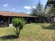 Backyard featuring a screened in porch, lush greenery, and ample room for gardening and outdoor activities at 31258 Park Ridge Dr, Brooksville, FL 34602