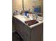 Bathroom vanity features updated fixtures, neutral paint, mirror, and a tiled backsplash at 31258 Park Ridge Dr, Brooksville, FL 34602