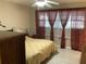 Bedroom featuring a ceiling fan, large window, and a bed with a nightstand at 31258 Park Ridge Dr, Brooksville, FL 34602