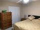 Bedroom featuring a dresser and a large bed with a nightstand at 31258 Park Ridge Dr, Brooksville, FL 34602