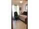 Cozy bedroom features a patterned daybed and a comfortable office chair at 31258 Park Ridge Dr, Brooksville, FL 34602