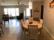 Bright dining area featuring an oval table, four woven chairs, tile floors and lots of natural light at 31258 Park Ridge Dr, Brooksville, FL 34602