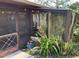 Charming screened porch exterior, surrounded by lush greenery and a welcoming ambiance at 31258 Park Ridge Dr, Brooksville, FL 34602