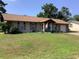 Charming single-story home featuring a well-kept lawn, stone accents, and an inviting front entrance at 31258 Park Ridge Dr, Brooksville, FL 34602