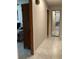 Hallway with tile flooring leading to rooms, including a bedroom and a view towards the kitchen at 31258 Park Ridge Dr, Brooksville, FL 34602
