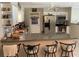 Well-lit kitchen with white cabinetry, stainless steel appliances, granite countertops, and breakfast bar seating at 31258 Park Ridge Dr, Brooksville, FL 34602