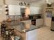 Spacious kitchen featuring granite counters, bar seating, and modern stainless appliances at 31258 Park Ridge Dr, Brooksville, FL 34602