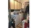 Practical laundry room with washer, dryer, and ample storage cabinets at 31258 Park Ridge Dr, Brooksville, FL 34602