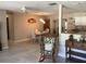 Inviting living room featuring tile floors, a rocking chair, and an open view to the dining area and kitchen at 31258 Park Ridge Dr, Brooksville, FL 34602