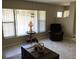 Comfortable living room featuring natural light from a large window, a recliner, and tile flooring at 31258 Park Ridge Dr, Brooksville, FL 34602