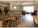 Open floor plan with a granite kitchen bar flowing into a living area with tile floors and comfortable seating at 31258 Park Ridge Dr, Brooksville, FL 34602