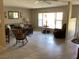 Bright living room featuring tile flooring, a comfortable sofa, and a view of the front window at 31258 Park Ridge Dr, Brooksville, FL 34602