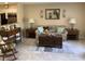 Comfortable living room featuring neutral walls, patterned sofa, decorative mirror, and stylish furnishings on tile floor at 31258 Park Ridge Dr, Brooksville, FL 34602