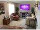 Cozy living room featuring comfortable sofas, mounted television and lots of plants at 31258 Park Ridge Dr, Brooksville, FL 34602