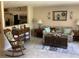 Cozy living room showcasing a sofa, accent tables, a rocking chair, and tile flooring at 31258 Park Ridge Dr, Brooksville, FL 34602