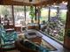 Inviting sunroom with a cozy seating area, charming decor, and an impressive indoor rock water feature at 31258 Park Ridge Dr, Brooksville, FL 34602
