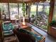 Inviting sunroom with a cozy seating area, charming decor, and an impressive indoor rock water feature at 31258 Park Ridge Dr, Brooksville, FL 34602
