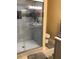 Shower featuring glass doors, tiled walls and flooring, built-in shelves, and overhead lighting at 31258 Park Ridge Dr, Brooksville, FL 34602